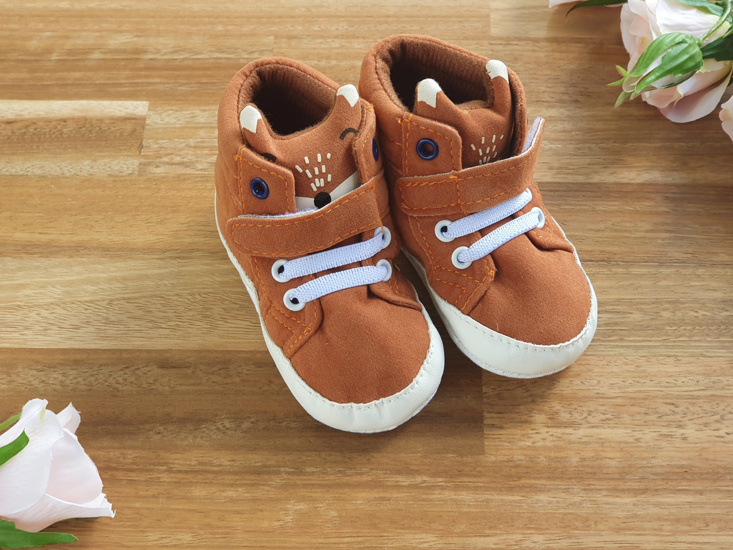 A pair of toddler's brown Fox themed booties with white laces and white soles